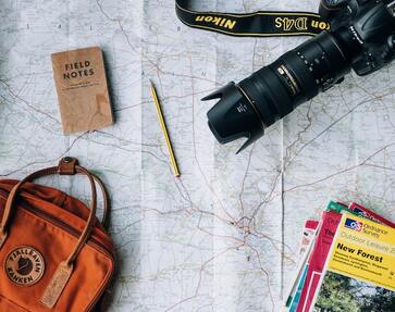 Travel accessories on a road map